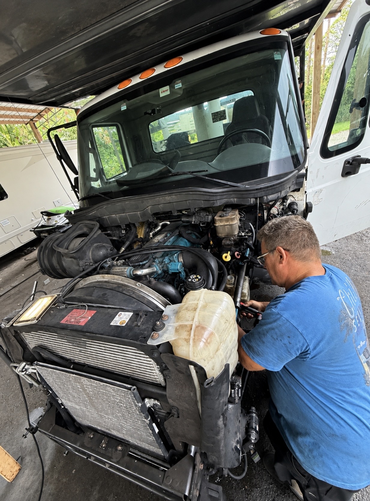 CV Equipment mechanic working on a truck